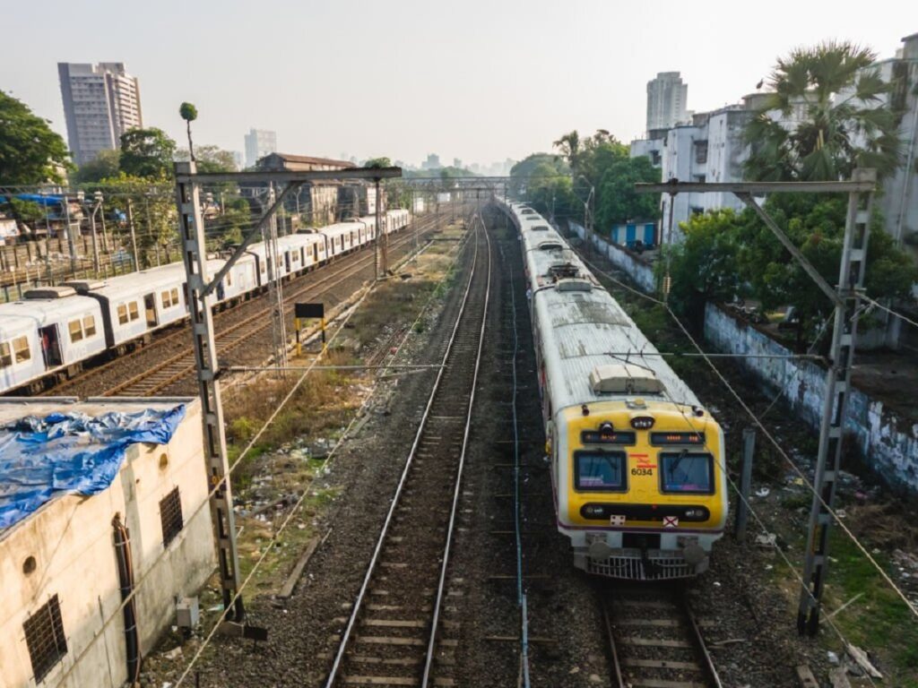 Mumbai, Maharashtra, India - November 2019: An aerial view of a  local train EMU running on the railway tracks of the Mumbai Suburban Railway.